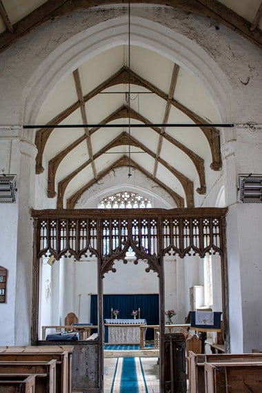Internal photo of a church, showing the aisle.